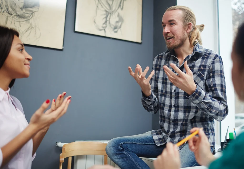 Therapist leading a DBT group therapy session for addiction recovery, helping clients build coping skills and emotional regulation at SoCal Beach Recovery in Southern California.