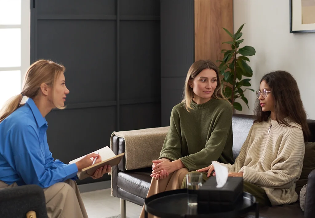 Therapist meeting with two women during addiction treatment counseling at SoCal Beach Recovery in Southern California.